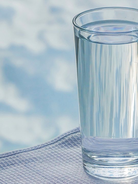A glass of clear drinking water, advertising a free in-home water test by Jones Air & Water