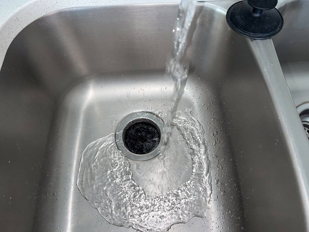 A water faucet in a kitchen sink